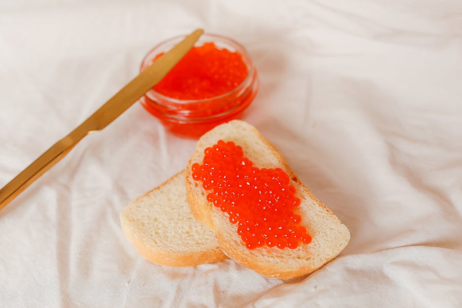 Open sandwich with butter and red salmon caviar on dark Russian rye bread