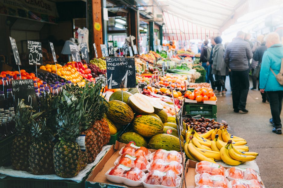 Busy covered food market in Russia with vendors displaying fresh produce, cheese, and specialty food stalls