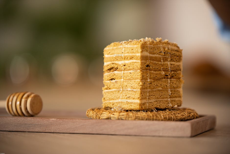 Slice of Russian medovik layered honey cake with cream filling on a plate