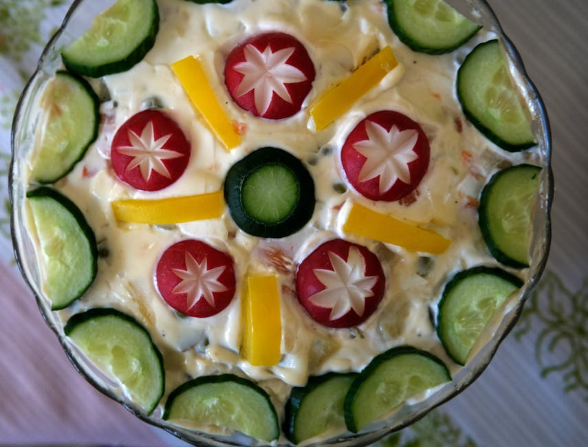 Traditional Russian Olivier salad with diced potatoes, carrots, peas, and mayonnaise in a serving bowl