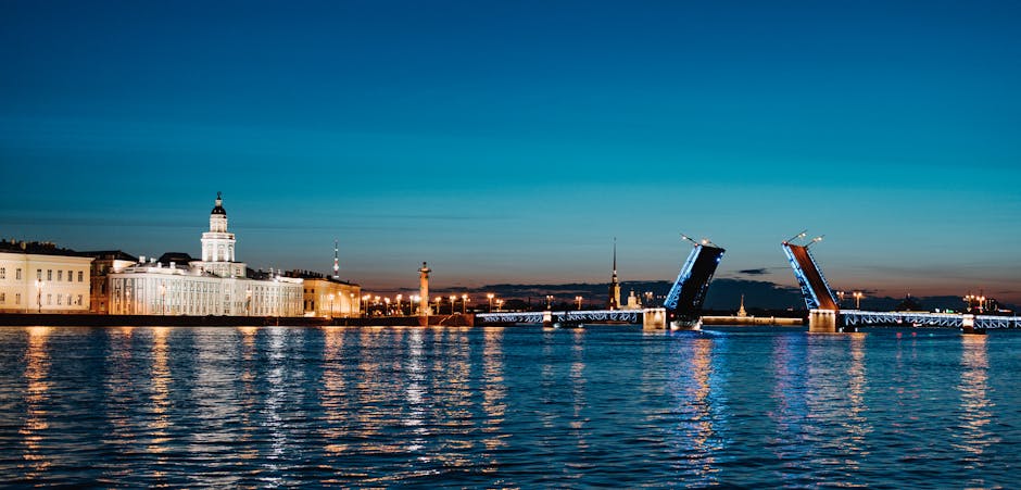 The Palace Bridge in Saint Petersburg raised at twilight with illuminated spans over the Neva River