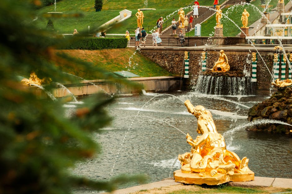 Peterhof Palace Grand Cascade fountains with gilded statues and sculpted gardens on a clear summer day